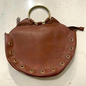 Circle handbag with metal ring handles